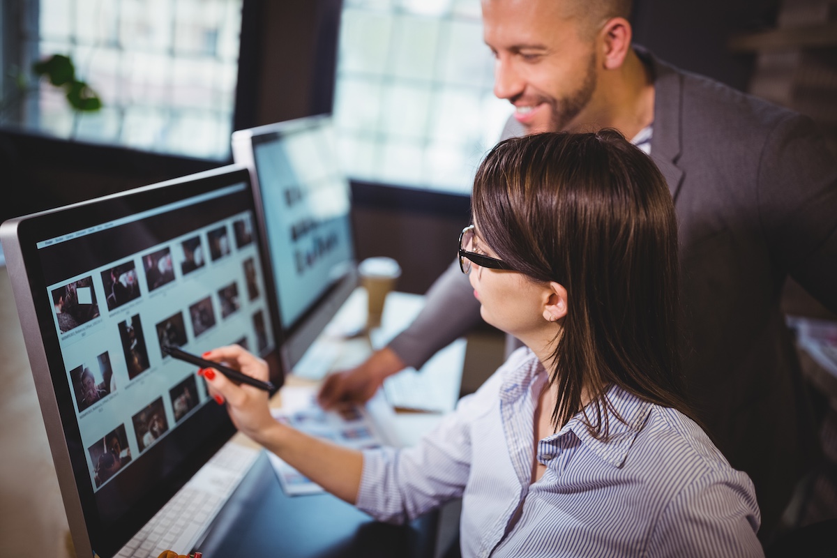 Creative professionals reviewing digital advertising content